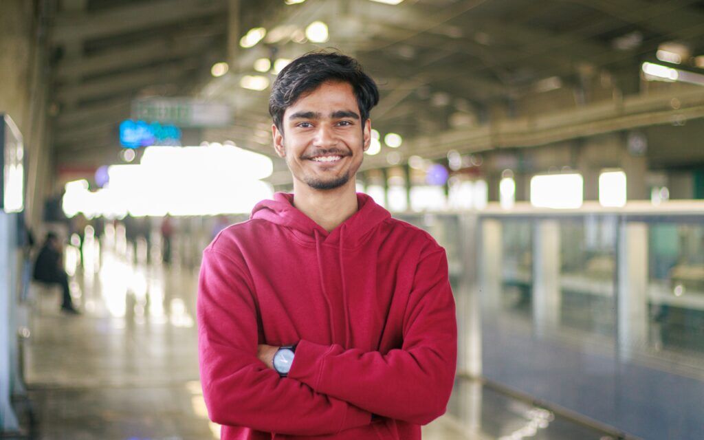 Smiling young man standing confidently, symbolizing hope and success from quality drug rehab in Austin, Texas.