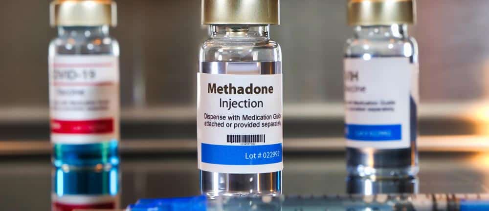 Three labeled methadone injection vials standing side by side, illustrating a synthetic opioid medication used in treating opioid use disorder and chronic pain.