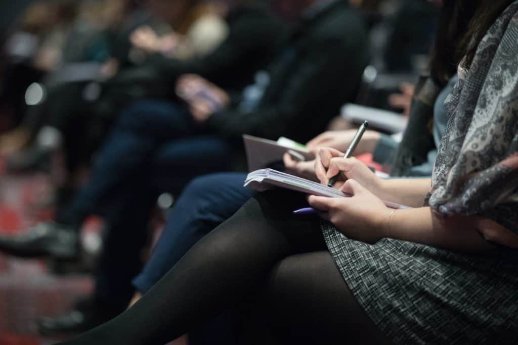 Group therapy participants taking notes during an intensive outpatient program in Austin, Texas.