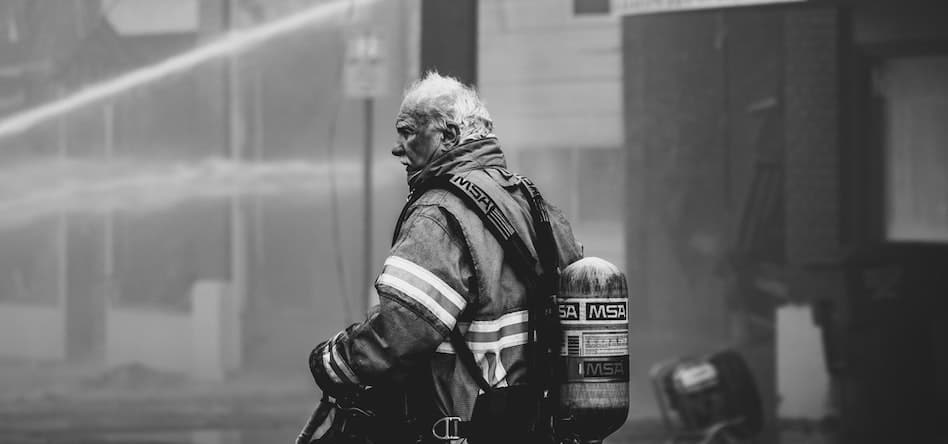 Firefighter in full gear during an emergency response—highlighting the risks of trauma, stress, and substance abuse among first responders.