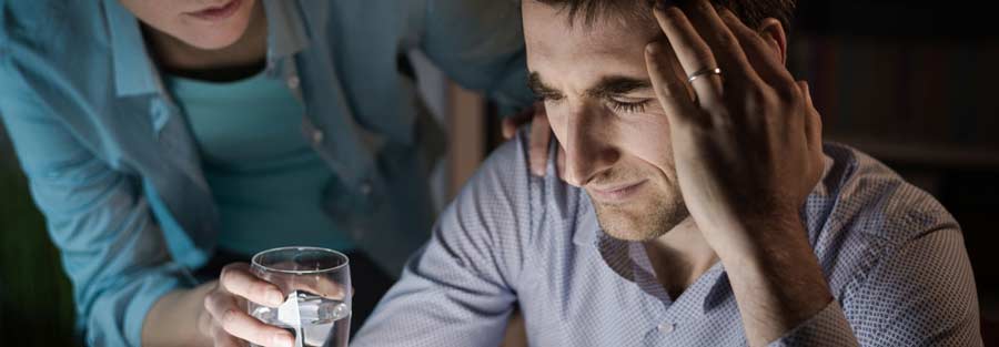 Worried man being comforted by a loved one showing signs of enabling addiction