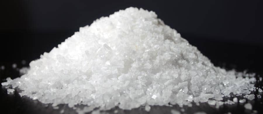 A close‑up of white crystalline granules resembling flakka (alpha‑PVP), a dangerous synthetic cathinone drug.
