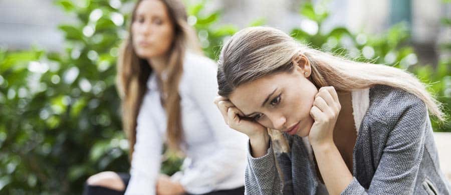 A concerned person comforting a distressed friend, capturing the emotional complexity of supporting someone who struggles with addiction.