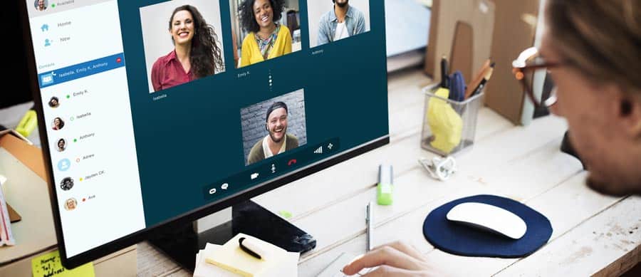 Person attending an online intensive outpatient program on a desktop video call, with multiple group members on screen.