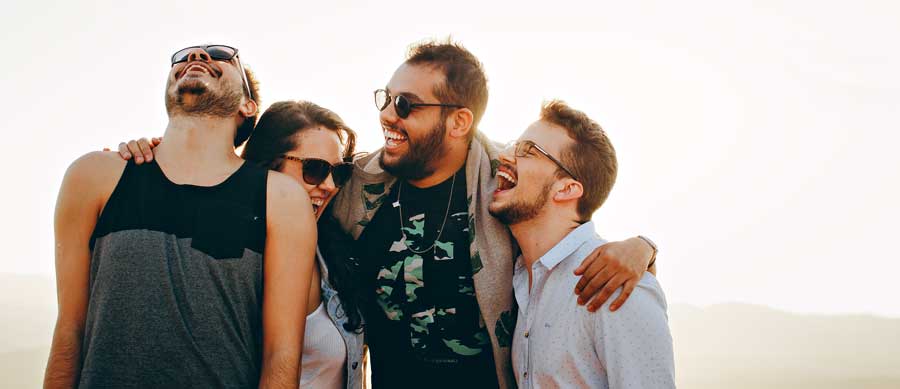 Friends laughing together outdoors, showing that sober life can be fun and fulfilling in recovery.