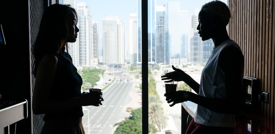 Two people discussing strategies during an addiction intervention in a modern city setting.