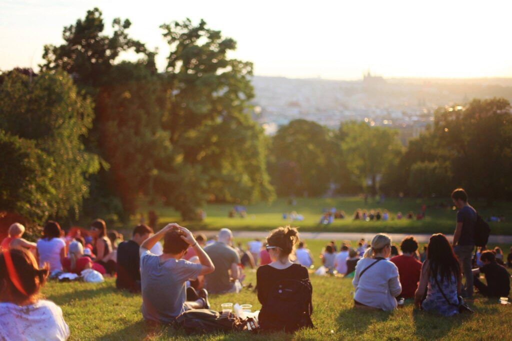 People enjoying a sunny day in a park in Austin, Texas, symbolizing community, connection, and a positive path in recovery.